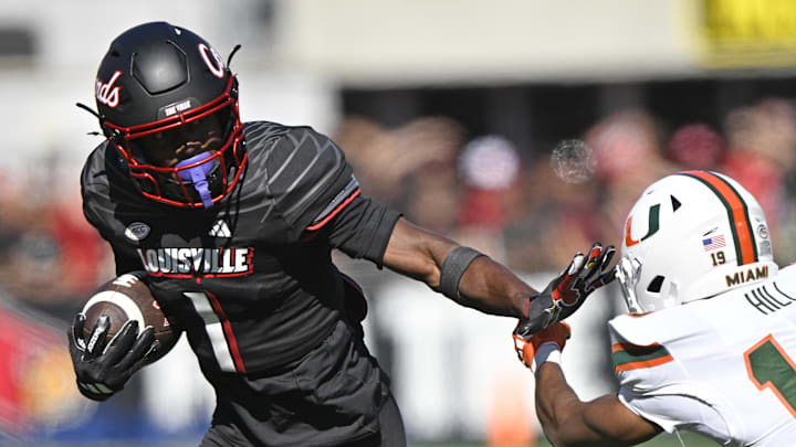 Oct 19, 2024; Louisville, Kentucky, USA; Louisville Cardinals wide receiver Ja'Corey Brooks (1) runs the ball against Miami Hurricanes defensive back D'Yoni Hill (19) during the second half at L&N Federal Credit Union Stadium. Miami defeated Louisville 52-45. Oct 19, 2024; Louisville, Kentucky, USA; Louisville Cardinals wide receiver Ja'Corey Brooks (1) runs the ball against Miami Hurricanes defensive back D'Yoni Hill (19) during the second half at L&N Federal Credit Union Stadium. Miami defeated Louisville 52-45.