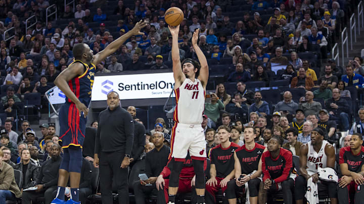 Jan 7, 2025; San Francisco, California, USA; Miami Heat forward Jaime Jaquez Jr. (11) takes a three-point shot as Golden State Warriors forward Draymond Green (23) defends during the second quarter at Chase Center. Mandatory Credit: John Hefti-Imagn Images