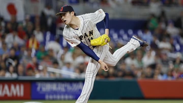 Mar 20, 2023; Miami, Florida, USA; Japan starting pitcher Roki Sasaki (14) delivers a pitch during the first inning against Mexico at LoanDepot Park. Mandatory Credit: Sam Navarro-Imagn Images