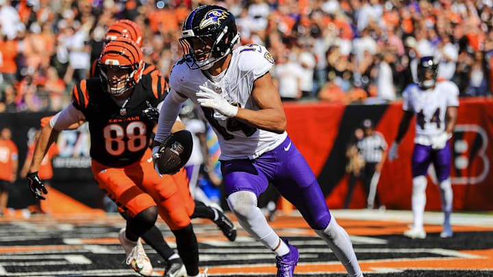 Oct 6, 2024; Cincinnati, Ohio, USA; Baltimore Ravens safety Kyle Hamilton (14) runs with the ball against Cincinnati Bengals tight end Mike Gesicki (88) in the first half at Paycor Stadium. Mandatory Credit: Katie Stratman-Imagn Images