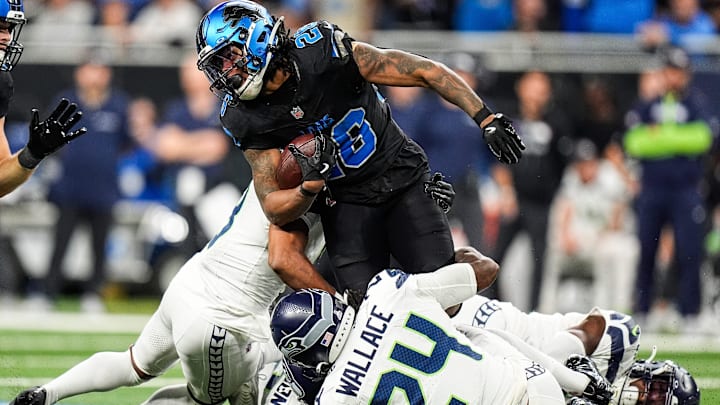 Detroit Lions running back Jahmyr Gibbs (26) runs for a first down against Seattle Seahawks safety K'Von Wallace (24) during the second half at Ford Field in Detroit on Monday, Sept. 30, 2024. Detroit Lions running back Jahmyr Gibbs (26) runs for a first down against Seattle Seahawks safety K'Von Wallace (24) during the second half at Ford Field in Detroit on Monday, Sept. 30, 2024.