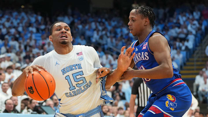 Nov 7, 2025; Chapel Hill, North Carolina, USA;  North Carolina Tar Heels forward Jarin Stevenson (15) with the balll as Kansas Jayhawks guard Elmarko Jackson (13) defends in the second half at Dean E. Smith Center. Mandatory Credit: Bob Donnan-Imagn Images