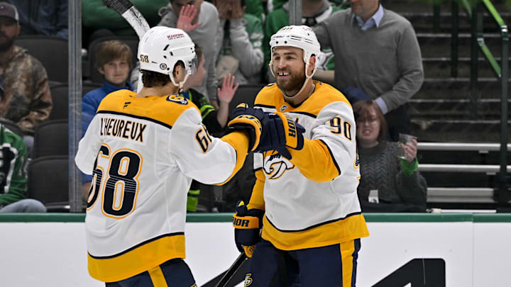 Dec 12, 2024; Dallas, Texas, USA; Nashville Predators left wing Zachary L'Heureux (68) and center Ryan O'Reilly (90) celebrates a goal scored by L'Heureux against the Dallas Stars during the third period at the American Airlines Center. Mandatory Credit: Jerome Miron-Imagn Images