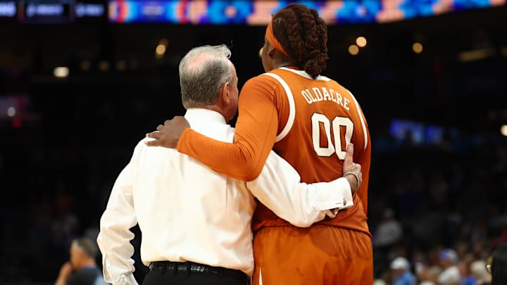 Apr 3, 2026; Phoenix, AZ, USA; Texas Longhorns head coach Vic Schaefer with center Kyla Oldacre (00) against the UCLA Bruins during a semifinal of the Final Four of the women's 2026 NCAA Tournament at Mortgage Matchup Center. Mandatory Credit: Mark J. Rebilas-Imagn Images