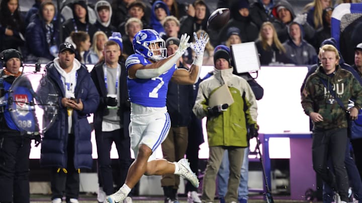 Nov 16, 2024; Provo, Utah, USA; Brigham Young Cougars running back Hinckley Ropati (7) catches a pass and runs for a touchdown against the Kansas Jayhawks during the second quarter at LaVell Edwards Stadium. Mandatory Credit: Rob Gray-Imagn Images Nov 16, 2024; Provo, Utah, USA; Brigham Young Cougars running back Hinckley Ropati (7) catches a pass and runs for a touchdown against the Kansas Jayhawks during the second quarter at LaVell Edwards Stadium. Mandatory Credit: Rob Gray-Imagn Images
