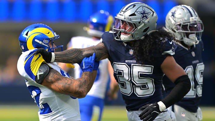 Dallas Cowboys linebacker Marist Liufau grabs a hold of Los Angeles Rams running back Cody Schrader. 