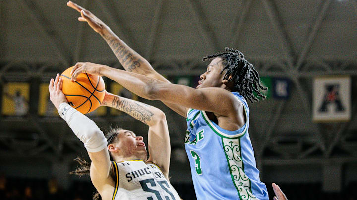 Feb 23, 2025; Wichita, Kansas, USA; Wichita State Shockers guard Bijan Cortes (55) shoots the ball around Tulane Green Wave guard Kam Williams (3) during the second half at Charles Koch Arena.