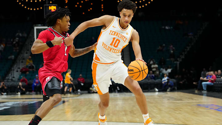 Nov 24, 2025; Las Vegas, NV, USA; Tennessee Volunteers forward Nate Ament (10) dribbles around Rutgers Scarlet Knights guard Jamichael Davis (1) during the first half in a 2025 Players Era Festival group play game at MGM Grand Garden Arena. Mandatory Credit: Stephen R. Sylvanie-Imagn Images