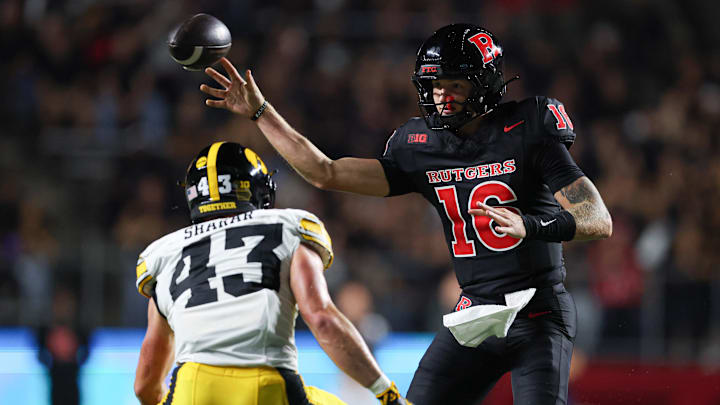 Sep 19, 2025; Piscataway, New Jersey, USA; Rutgers Scarlet Knights quarterback Athan Kaliakmanis (16) passes the ball during the first half as Iowa Hawkeyes linebacker Karson Sharar (43) defends at SHI Stadium. Mandatory Credit: Vincent Carchietta-Imagn Images