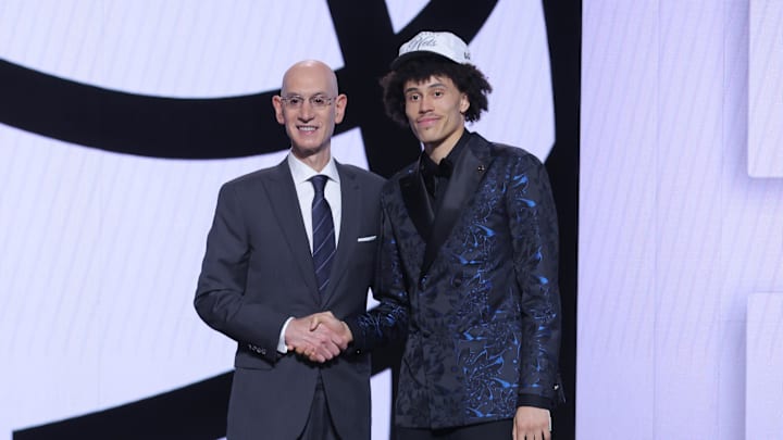Jun 25, 2025; Brooklyn, NY, USA;  Nolan Traore stands with NBA commissioner Adam Silver after being selected as the 19th pick by the Brooklyn Nets in the first round of the 2025 NBA Draft at Barclays Center. Mandatory Credit: Brad Penner-Imagn Images