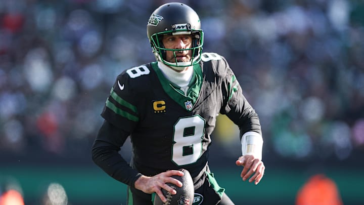 Dec 1, 2024; East Rutherford, New Jersey, USA; New York Jets quarterback Aaron Rodgers (8) scrambles during the first quarter against the New York Jets at MetLife Stadium.