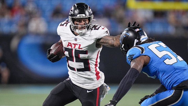 Oct 13, 2024; Charlotte, North Carolina, USA; Atlanta Falcons running back Tyler Allgeier (25) stiff arms Carolina Panthers linebacker Chandler Wooten (57) during the second half at Bank of America Stadium. Mandatory Credit: Jim Dedmon-Imagn Images