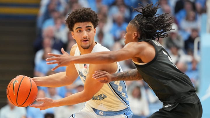 Feb 28, 2026; Chapel Hill, North Carolina, USA; North Carolina Tar Heels guard Derek Dixon (3) looks to pass as Virginia Tech Hokies guard Ben Hammond (3) defends in the second half at Dean E. Smith Center. Mandatory Credit: Bob Donnan-Imagn Images