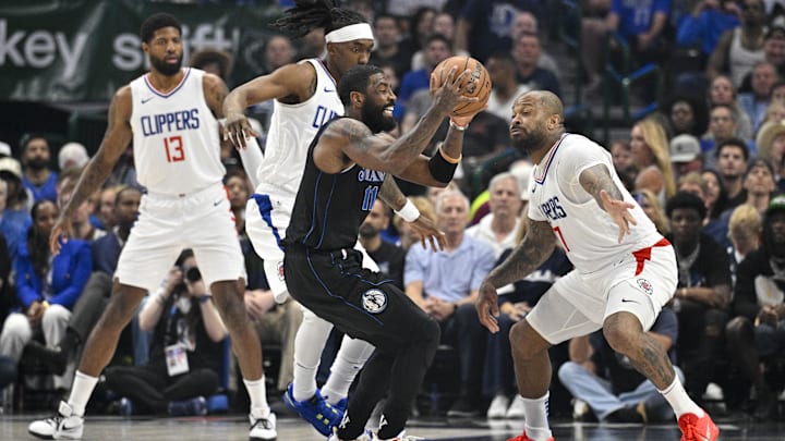 May 3, 2024; Dallas, Texas, USA; Dallas Mavericks guard Kyrie Irving (11) moves the ball past LA Clippers forward Paul George (13) and guard Terance Mann (14) and forward P.J. Tucker (17) during the first quarter during game six of the first round for the 2024 NBA playoffs at American Airlines Center. Mandatory Credit: Jerome Miron-Imagn Images