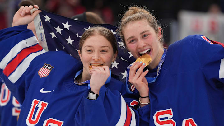 Feb 19, 2026; Milan, Italy; Aerin Frankel (31) of the United States and Caroline Harvey (4) of the United States celebrate after winning the gold medal in women's ice hockey after defeating Canada during the Milano Cortina 2026 Olympic Winter Games at Milano Santagiulia Ice Hockey Arena. Mandatory Credit: Amber Searls-Imagn Images