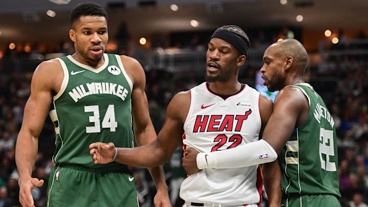 Jimmy Butler stands between Bucks stars Giannis Antetokounmpo and Khris Middleton during a game in 2023.