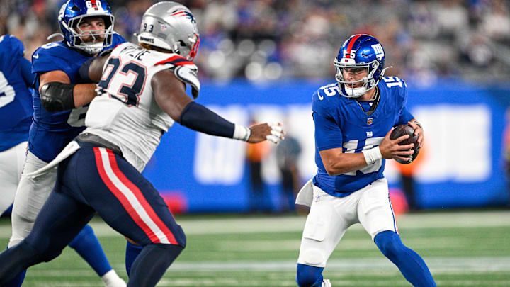 Aug 21, 2025; East Rutherford, New Jersey, USA; New York Giants quarterback Tommy DeVito (15) runs with the ball chased by New England Patriots defensive tackle Jahvaree Ritzie (93) during the third quarter at MetLife Stadium. Mandatory Credit: Mark Smith-Imagn Images