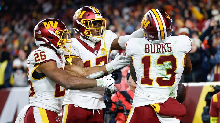 Nov 30, 2025; Landover, Maryland, USA; Washington Commanders wide receiver Treylon Burks (13) celebrates after scoring a touchdown against the Denver Broncos with running back Jeremy McNichols (26) and wide receiver Terry McLaurin (17) in the third quarter of the game at Northwest Stadium. Mandatory Credit: Peter Casey-Imagn Images Nov 30, 2025; Landover, Maryland, USA; Washington Commanders wide receiver Treylon Burks (13) celebrates after scoring a touchdown against the Denver Broncos with running back Jeremy McNichols (26) and wide receiver Terry McLaurin (17) in the third quarter of the game at Northwest Stadium. Mandatory Credit: Peter Casey-Imagn Images
