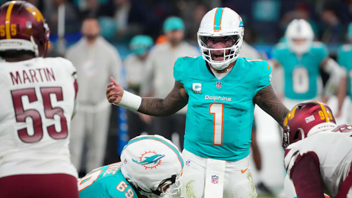Miami Dolphins quarterback Tua Tagovailoa (1) calls a play at the line of scrimmage against the Washington Commanders in overtime during the 2025 NFL Madrid Game at Santiago Bernabeu Stadium. 