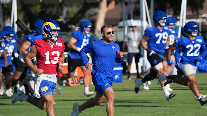 Jul 23, 2025; Los Angeles, CA, USA; Los Angeles Rams coach Sean McVay runs with quarterback Stetson Bennett (13) during training camp at Loyola Marymount University. Mandatory Credit: Kirby Lee-Imagn Images
