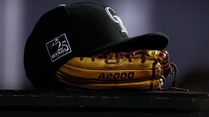 Sep 5, 2018; Denver, CO, USA; A detail view of a Colorado Rockies hat on top of a glove in the seventh inning against the San Francisco Giants at Coors Field.
