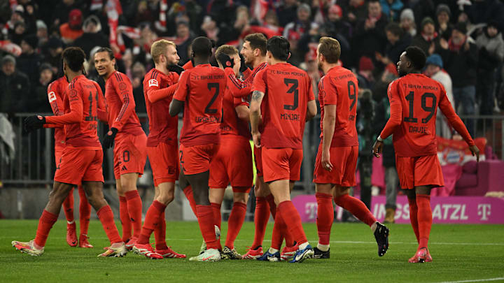 Bayern Munich players celebrating a goal against VFL Wolfsburg.