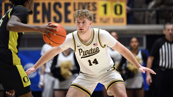 Purdue Boilermakers guard Jack Benter (14) defends against Oregon Ducks guard Takai Simpkins (5).