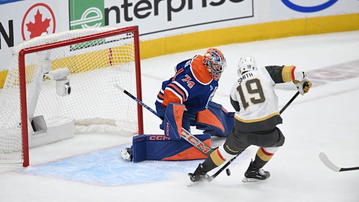 May 10, 2025; Edmonton, Alberta, CAN; Edmonton Oilers goalie Stuart Skinner (74) battles for the puck with Vegas Golden Knights right winger Reilly Smith (19) during the first period in game three of the second round of the 2025 Stanley Cup Playoffs at Rogers Place. Mandatory Credit: Walter Tychnowicz-Imagn Images