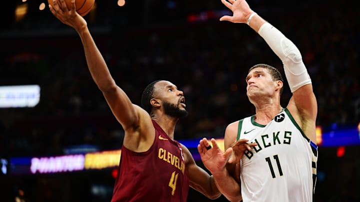 Nov 4, 2024; Cleveland, Ohio, USA; Cleveland Cavaliers forward Evan Mobley (4) drives to the basket against Milwaukee Bucks center Brook Lopez (11) during the second half at Rocket Mortgage FieldHouse. Mandatory Credit: Ken Blaze-Imagn Images
