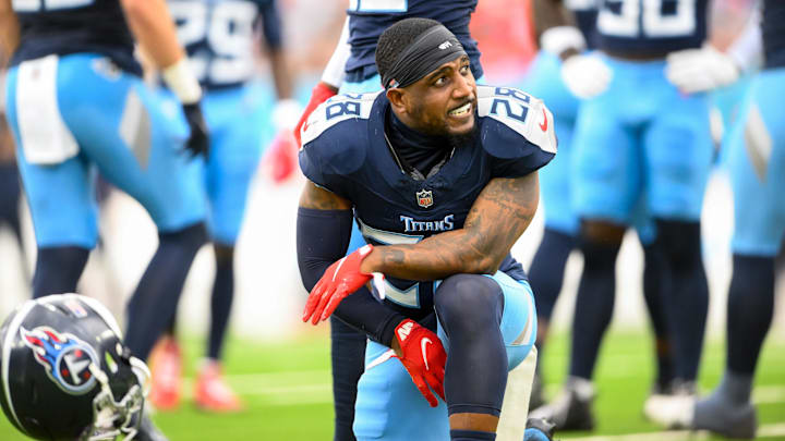 Tennessee Titans safety Quandre Diggs slams his helmet down after an ankle injury against the New England Patriots.
