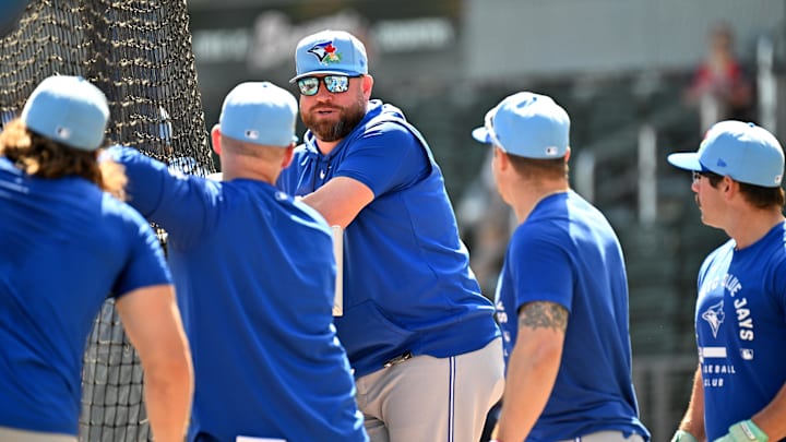Toronto Blue Jays manager John Schneider (14) talks with a group of players before the start of the game. Toronto Blue Jays manager John Schneider (14) talks with a group of players before the start of the game.