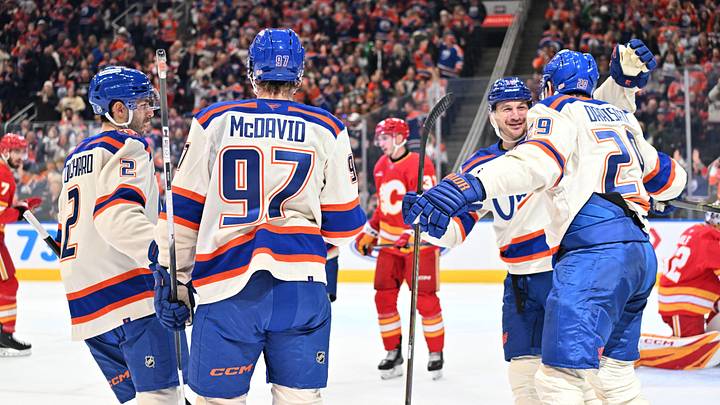 Dec 23, 2025; Edmonton, Alberta, CAN; Edmonton Oilers defenseman Evan Bouchard (2) along with Oilers center Connor McDavid (97) with Edmonton Oilers center Leon Draisaitl (29) and Oilers left winger Zach Hyman (18) celebrate a goal on Calgary Flames goalie Dustin Wolf (32) during the first period at Rogers Place. Mandatory Credit: Walter Tychnowicz-Imagn Images