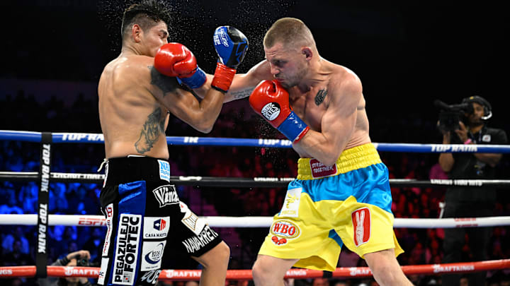 Denys Berinchyk (right) and Emanuel Navarette exchange blows in their fight for the WBO lightweight title.