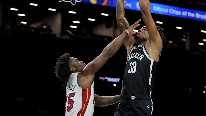 Dec 18, 2025; Brooklyn, New York, USA; Brooklyn Nets center Nic Claxton (33) dunks against Miami Heat guard Davion Mitchell (45) during the first quarter at Barclays Center. Mandatory Credit: Brad Penner-Imagn Images