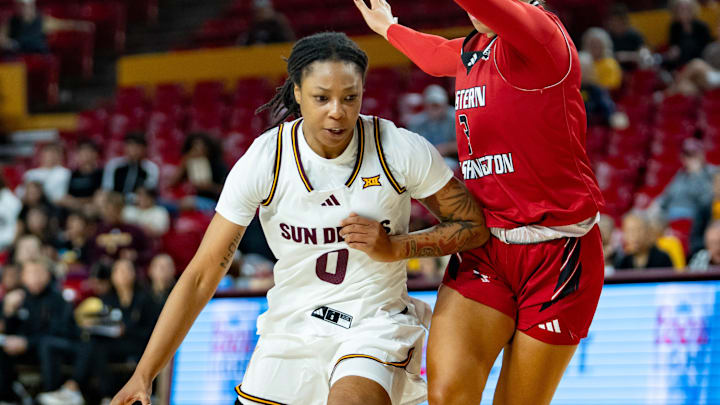Arizona State Sun Devils Gabby Elliott (0) runs with the ball against Eastern Washington Eagles Madeline Gibbs (3) during a game at Desert Financial Arena in Tempe, on Nov. 8, 2025.