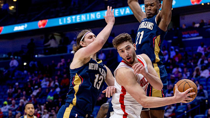 Mar 6, 2025; New Orleans, Louisiana, USA;  Houston Rockets center Alperen Sengun (28) passes the ball around New Orleans Pelicans center Yves Missi (21) and forward Kelly Olynyk (13) during the second half at Smoothie King Center. Mandatory Credit: Stephen Lew-Imagn Images