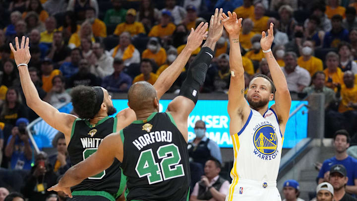 Jun 13, 2022; San Francisco, California, USA; Golden State Warriors guard Stephen Curry (30) shoots the ball over Boston Celtics guard Derrick White (9) and forward Al Horford (42) during the first half in game five of the 2022 NBA Finals at Chase Center. Mandatory Credit: Kyle Terada-Imagn Images
