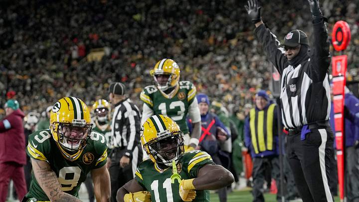 Green Bay Packers wide receiver Jayden Reed (11) celebrates his touchdown reception with wide receiver Christian Watson (9) during the second quarter of their game against the Miami Dolphins Thursday, November 28, 2024 at Lambeau Field in Green Bay, Wisconsin.