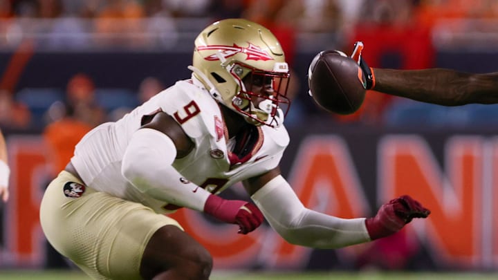 Oct 26, 2024; Miami Gardens, Florida, USA; Miami Hurricanes wide receiver Isaiah Horton (2) attempts but cannot catch the football against Florida State Seminoles defensive back Azareye'h Thomas (8) and linebacker Omar Graham Jr. (9) during the fourth quarter at Hard Rock Stadium. Mandatory Credit: Sam Navarro-Imagn Images