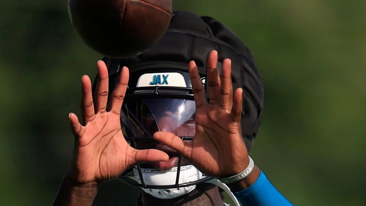 Jacksonville Jaguars wide receiver Brian Thomas Jr. (7) catches a pass during soft toss with Jacksonville Jaguars wide receiver Dyami Brown (5), not shown, during an NFL training camp session at the Miller Electric Center, Wednesday, July 23, 2025, in Jacksonville, Fla. [Corey Perrine/Florida Times-Union]