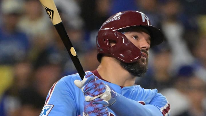 Oct 8, 2025; Los Angeles, California, USA; Philadelphia Phillies designated hitter Kyle Schwarber (12) watches the flight of the ball a solo home run during the fourth inning against the Los Angeles Dodgers in game three of the NLDS during the 2025 MLB playoffs at Dodger Stadium. Mandatory Credit: Jayne Kamin-Oncea-Imagn Images