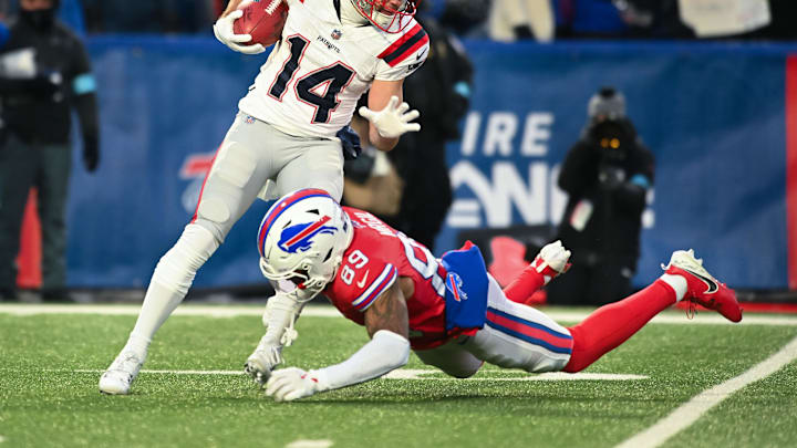 Dec 22, 2024; Orchard Park, New York, USA; New England Patriots wide receiver Alex Erickson (14) is tackled by Buffalo Bills wide receiver Jalen Virgil (89) on a kickoff return