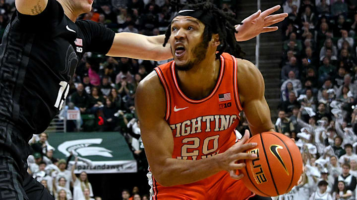 Feb 10, 2024; East Lansing, Michigan, USA;  Illinois Fighting Illini forward Ty Rodgers (20) looks for a shot against Michigan State Spartans center Carson Cooper (15) during the first half at Jack Breslin Student Events Center. Mandatory Credit: Dale Young-Imagn Images