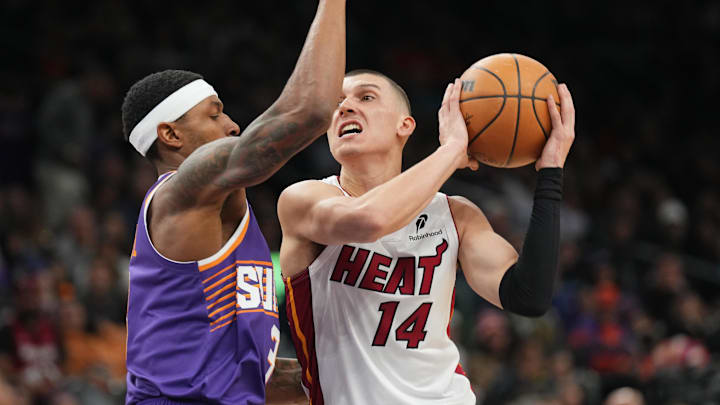 Nov 6, 2024; Phoenix, Arizona, USA; Miami Heat guard Tyler Herro (14) drives against Phoenix Suns guard Bradley Beal (3) during the second half at Footprint Center. Nov 6, 2024; Phoenix, Arizona, USA; Miami Heat guard Tyler Herro (14) drives against Phoenix Suns guard Bradley Beal (3) during the second half at Footprint Center.