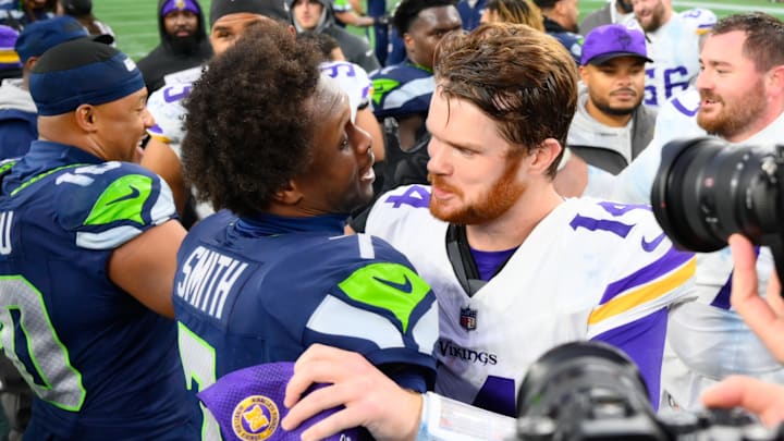Dec 22, 2024; Seattle, Washington, USA; Seattle Seahawks quarterback Geno Smith (7) and Minnesota Vikings quarterback Sam Darnold (14) hug after the game at Lumen Field. Dec 22, 2024; Seattle, Washington, USA; Seattle Seahawks quarterback Geno Smith (7) and Minnesota Vikings quarterback Sam Darnold (14) hug after the game at Lumen Field.