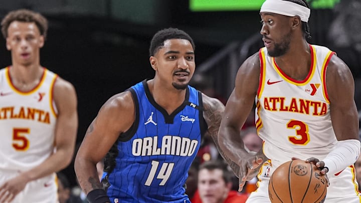 Feb 20, 2025; Atlanta, Georgia, USA; Atlanta Hawks guard Caris LeVert (3) dribbles in front of Orlando Magic guard Gary Harris (14) during the first half at State Farm Arena. Mandatory Credit: Dale Zanine-Imagn Images