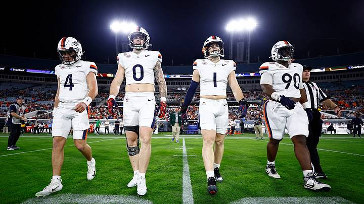 Quarterback Chandler Morris (4), tight end Sage Ennis (0), linebacker James Jackson (1) and defensive lineman Jahmeer Carter (90), Virginia's captains, approach Missouri at midfield for the TaxSlayer Gator Bowl coin toss, Dec. 27, 2025. Quarterback Chandler Morris (4), tight end Sage Ennis (0), linebacker James Jackson (1) and defensive lineman Jahmeer Carter (90), Virginia's captains, approach Missouri at midfield for the TaxSlayer Gator Bowl coin toss, Dec. 27, 2025.