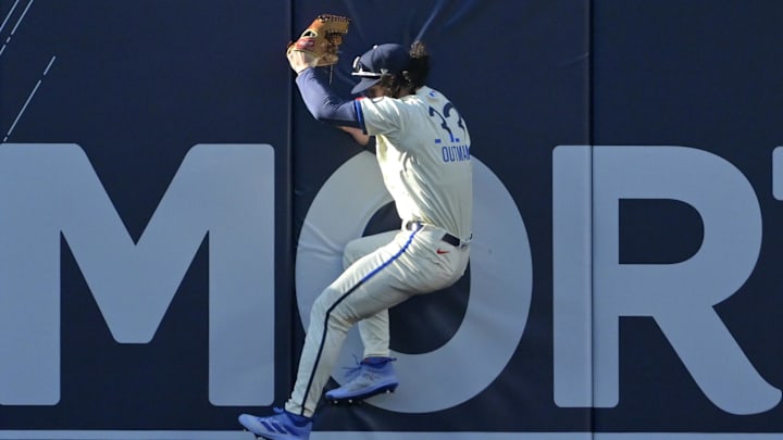 Jul 20, 2024; Los Angeles, California, USA;  Los Angeles Dodgers center fielder James Outman (33) makes a leaping catch at the wall off a ball hit by Boston Red Sox right fielder Rob Refsnyder (30) in the seventh inning at Dodger Stadium. Mandatory Credit: Jayne Kamin-Oncea-Imagn Images