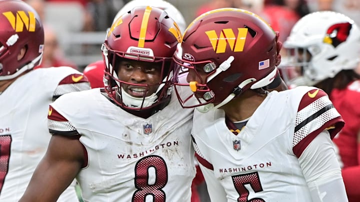 Sep 29, 2024; Glendale, Arizona, USA;  Washington Commanders running back Brian Robinson Jr. (8) celebrates with quarterback Jayden Daniels (5) after scoring a touchdown  in the first half against the Arizona Cardinals at State Farm Stadium. Mandatory Credit: Matt Kartozian-Imagn Images