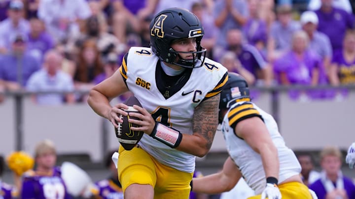 Sep 14, 2024; Greenville, North Carolina, USA;  Appalachian State Mountaineers quarterback Joey Aguilar (4) rolls out of the pocket against the East Carolina Pirates during the first half at Dowdy-Ficklen Stadium. Mandatory Credit: James Guillory-Imagn Images